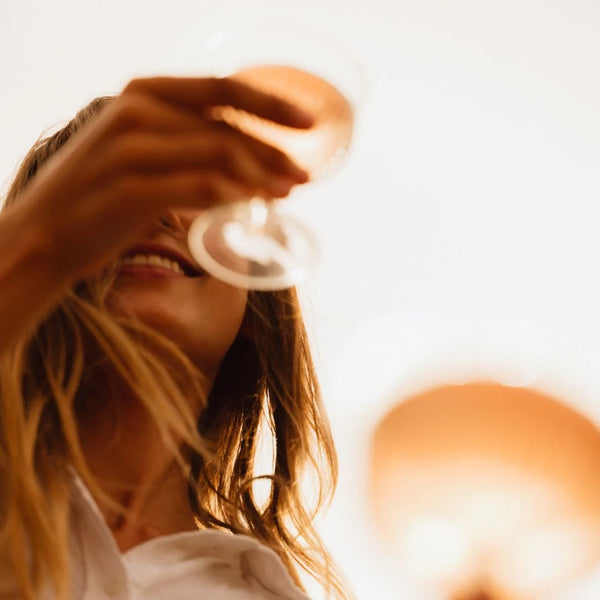 Woman drinking a glass of L.A Brewery Sparkling English Blush on a sunny day