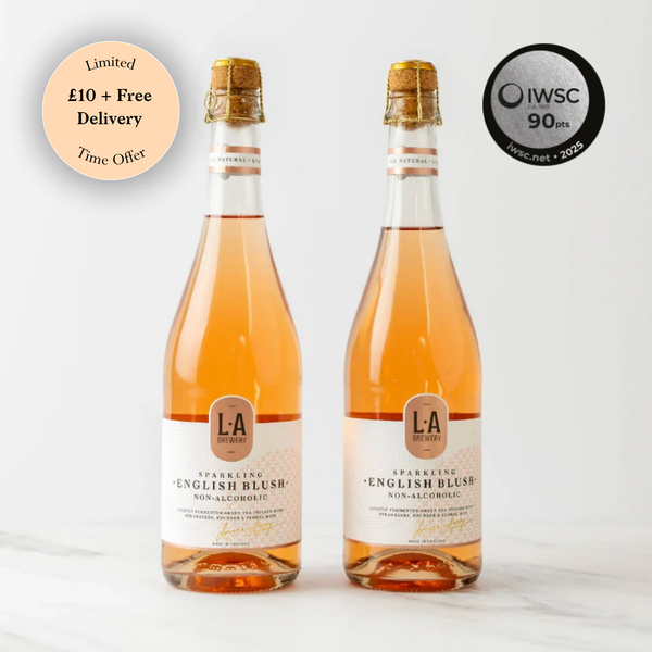 Two bottles of L.A. Brewery Sparkling English Blush non-alcoholic wine on a white background with IWSC 90+ points badge.